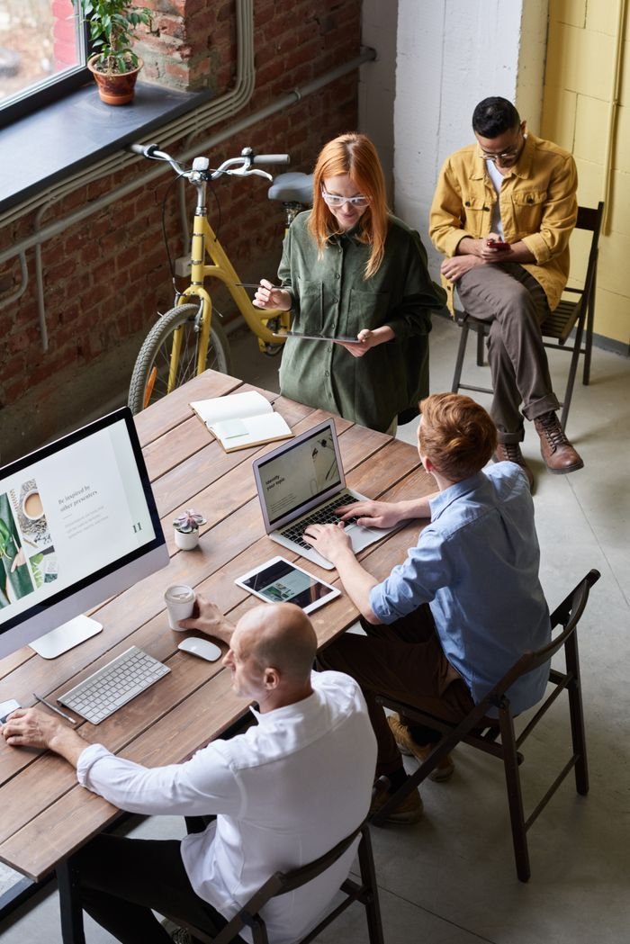 Services Casual workspace with diverse team working and interacting in a modern office.